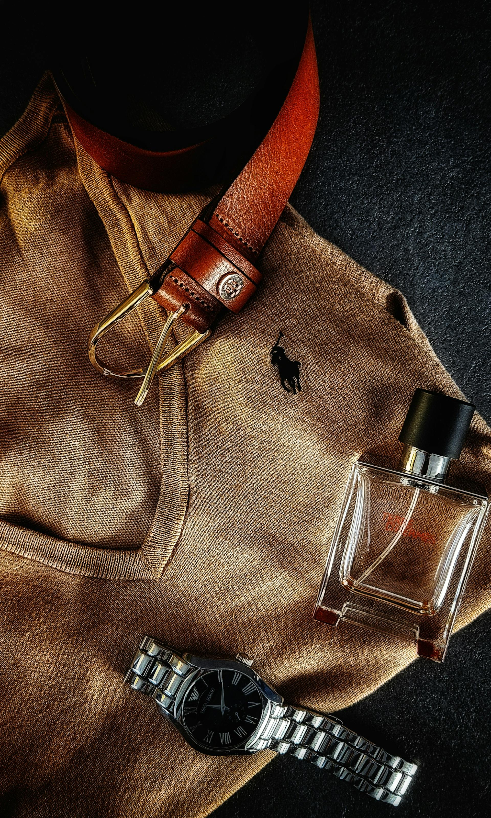 Leather belt with neutral fashion accessories laid out